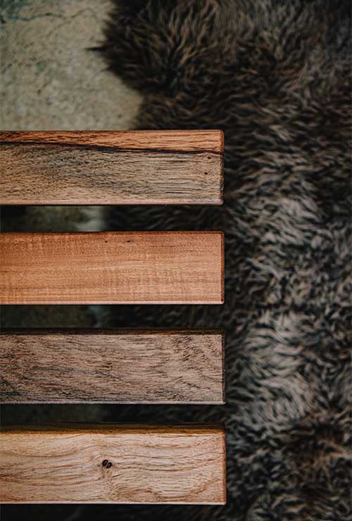 The grain of our responsibly sourced American Pecan wood against a lush shearling rug. 